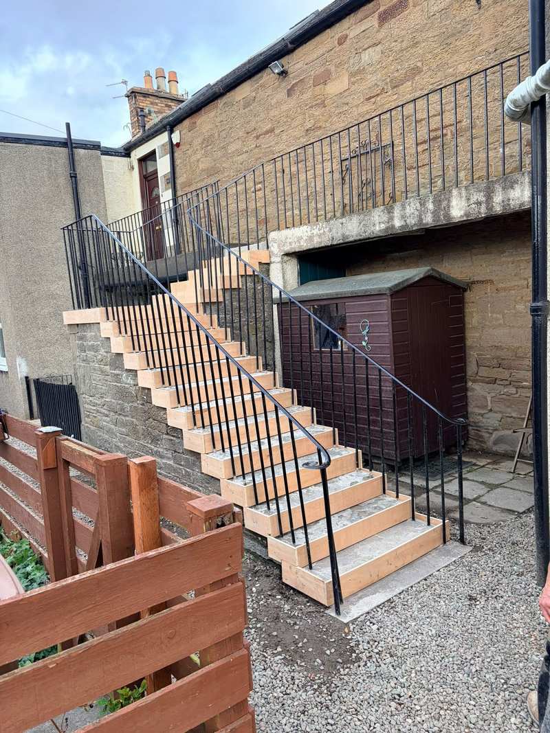 Timber formwork boards fixed to the front of each step on an external stair during repair
