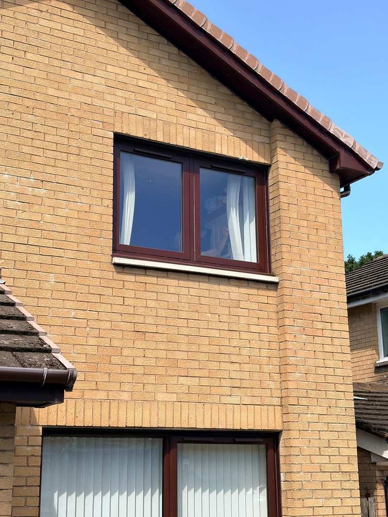 New pale window cill under a first floor window in a buff brick gable